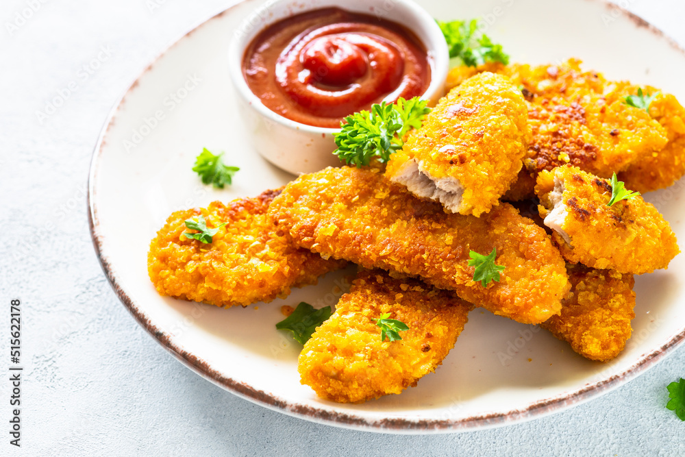 Chicken nuggets with ketchup sauce at white table. Chicken nuggets with ketchup sauce at white table.