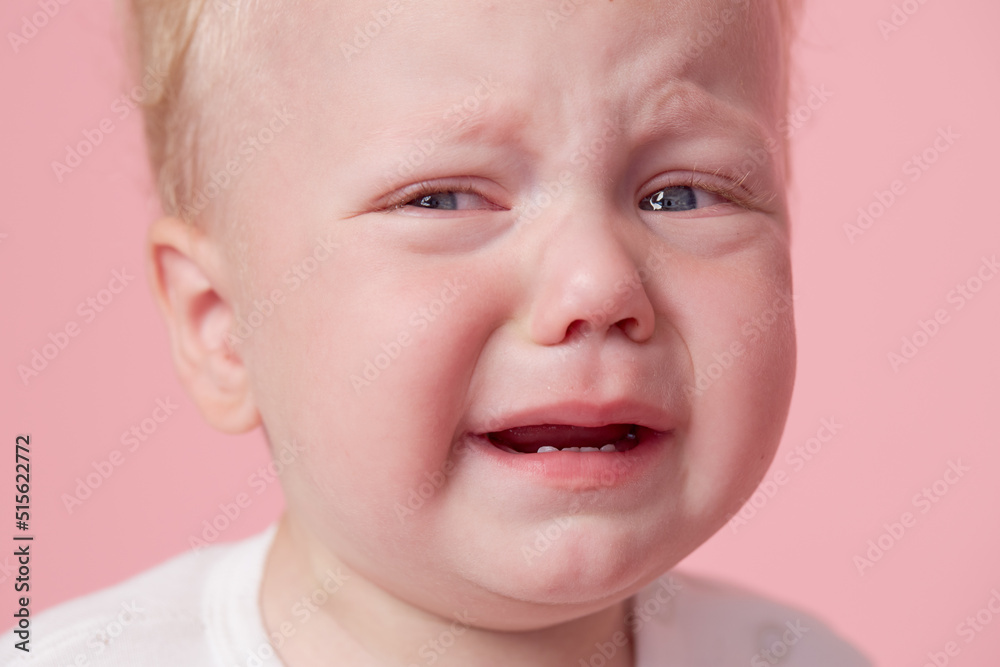 Crying baby boy isolated on pink background Crying baby boy isolated on pink background