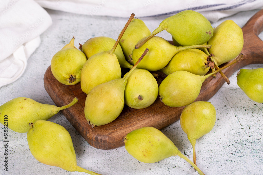 Fresh pear. Ripe pears in a wooden serving dish on a stone background. Bulk pear. close up