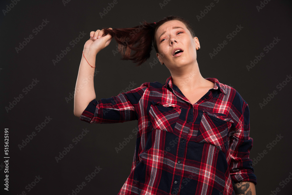 Female model playing with her ponytail Female model playing with her ponytail
