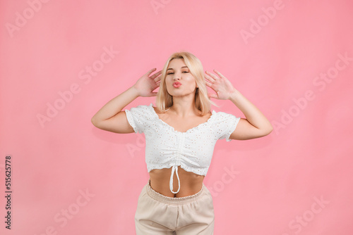 very beautiful young girl posing with emotions on a pink background