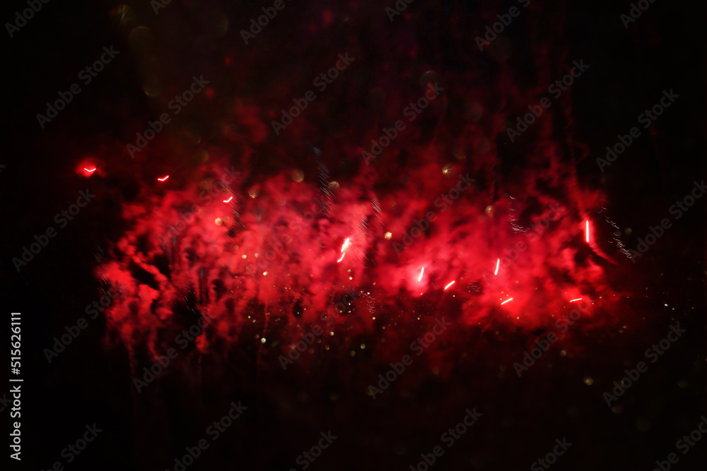 abstract black, red and gold glitter background with fireworks