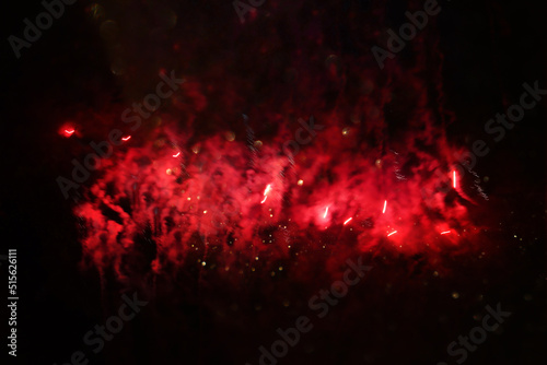 abstract black, red and gold glitter background with fireworks