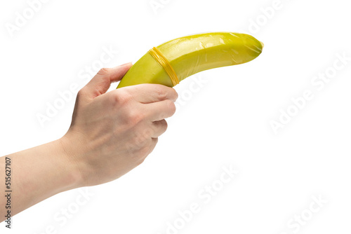 Woman put on a condom on a banana. Isolated on white background.