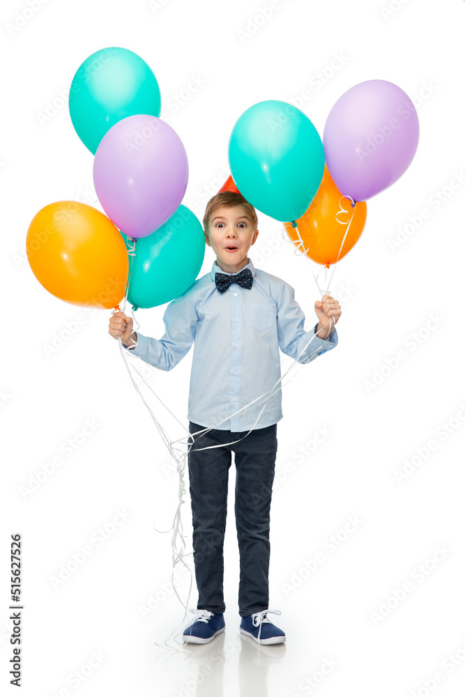 birthday, childhood and people concept - portrait of smiling little boy in party hat with balloons over white background birthday, childhood and people concept - portrait of smiling little boy in party hat with balloons over white background