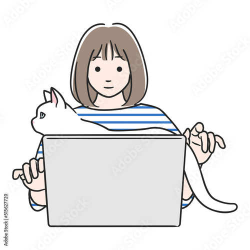 パソコン作業中、猫に邪魔される女性