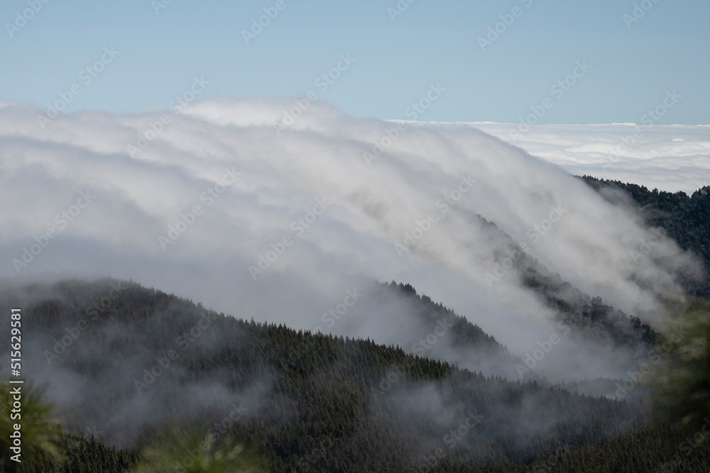 Fog flows down the mountain