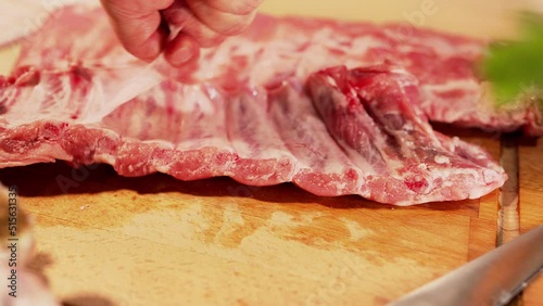 Silverskin or peritoneum being removed from a rack of pork spareribs