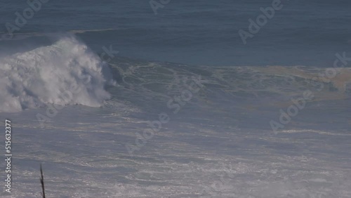 Huge waves at Nazare in Portugal where surfers are being towed in to ride the giant 80 foot waves. photo