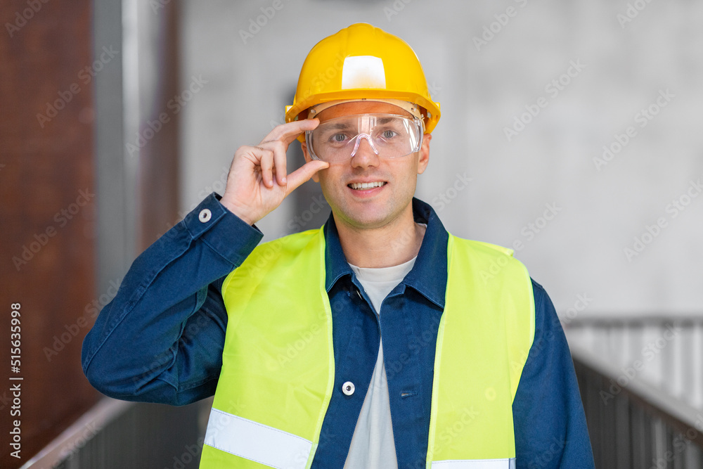 architecture, construction business and building concept - happy smiling male architect in helmet, goggles and safety west at office architecture, construction business and building concept - happy smiling male architect in helmet, goggles and safety west at office