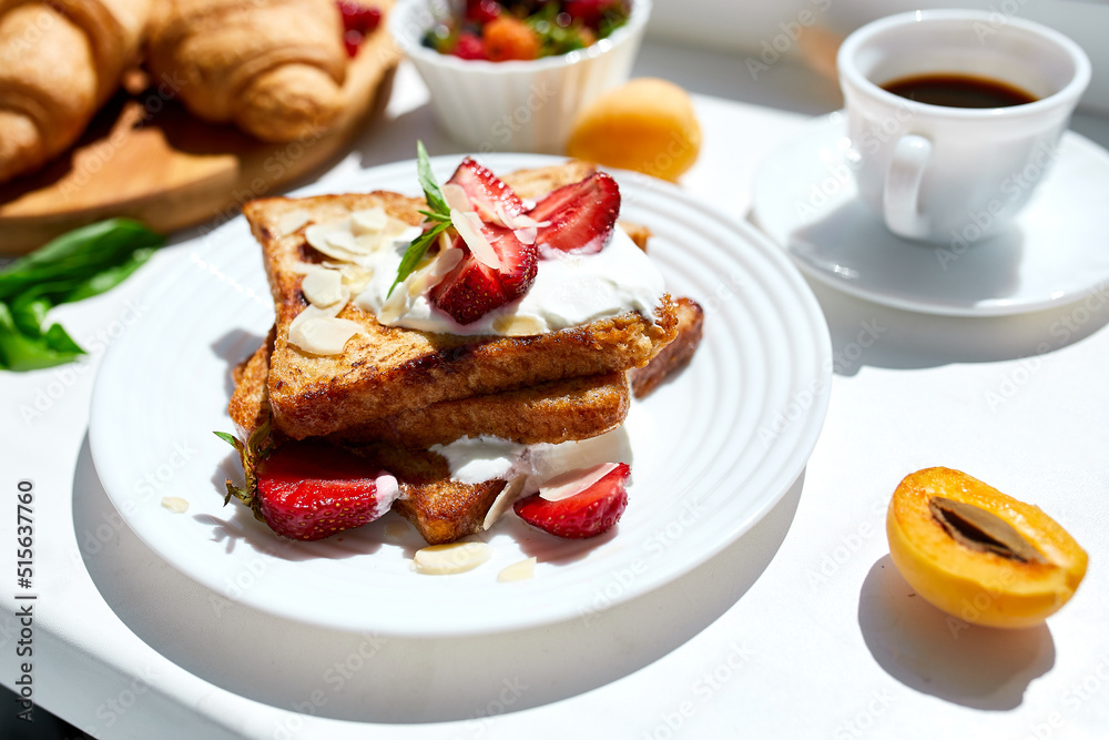 Breakfast of french toast with strawberries and maple syrup, good morning.. Breakfast of french toast with strawberries and maple syrup, good morning..