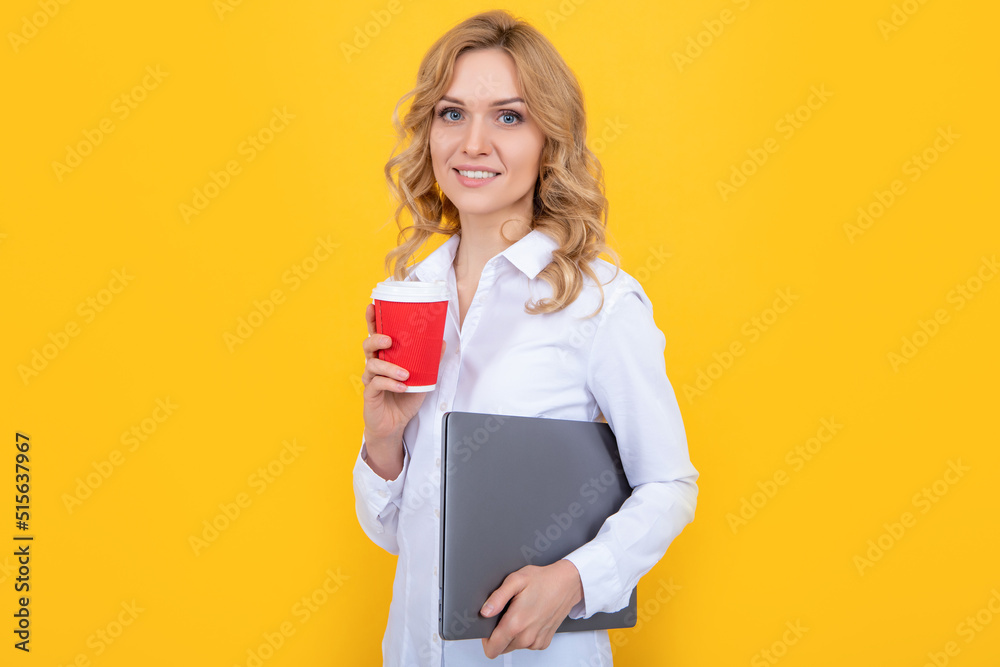Fototapeta premium smiling blonde woman with coffee cup and laptop on yellow background