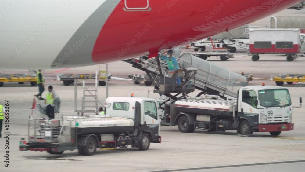 Airport Ground Crew At Work on  Quantas Airplane At The Changi Airport In Singapore