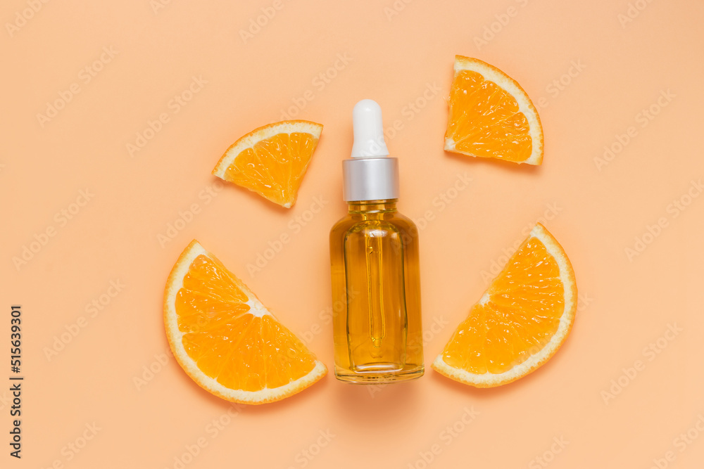 Glass bottle of face serum or oil with sliced oranges Glass bottle of face serum or oil with sliced oranges
