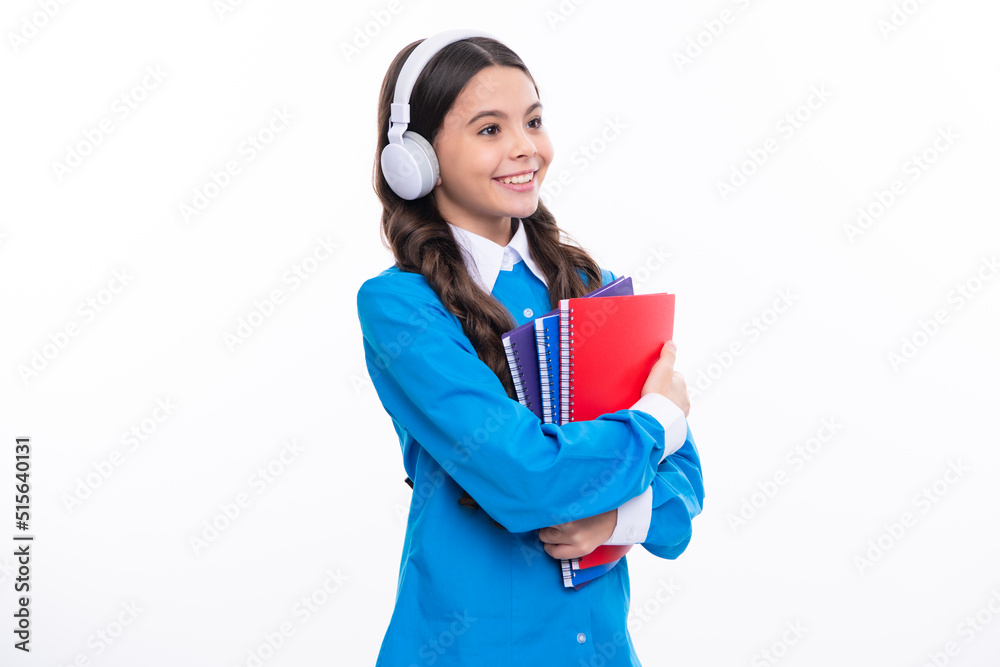 School teen girl in headphones hold book notebooks. Listen to music. School teen girl in headphones hold book notebooks. Listen to music.