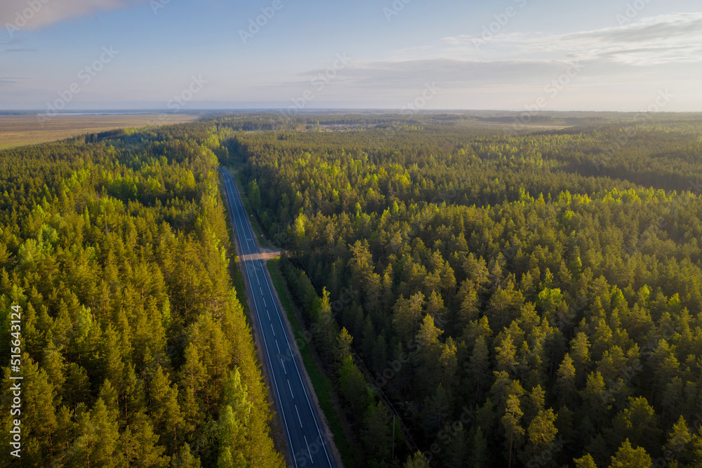 Aerial view of a road near by Ladoga lake on sunnyb summer morning. Surroundings of Kokkorevo village, Leningrad Oblast, Russia.