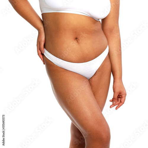 Woman with fat abdomen, overweight female body on white background, studio shot,posing in lingerie on a white background