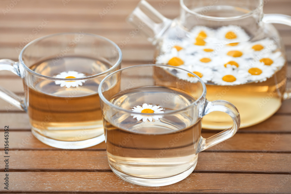 Morning breakfast with two cups of chamomile tea and glass transparent teapot on wooden table
Morning breakfast with two cups of chamomile tea and glass transparent teapot on wooden table