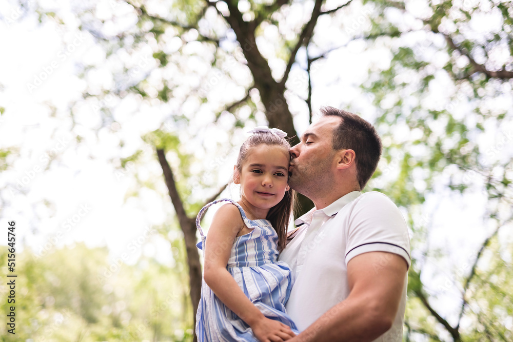 Fototapeta premium Father with his daughter having fun outside in forest