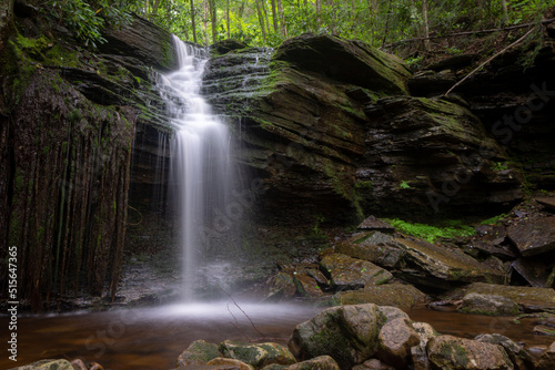 Waterfall in forest cascading down rocks slow shutter speed horizontal