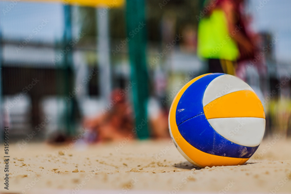 Volleyball ball stands on the sand during the competition