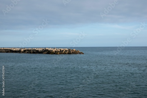 View of a stone dock in the sea in Estreito da Calheta photo