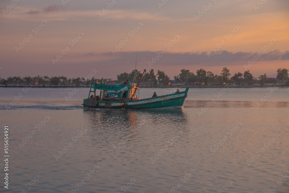 Khmer fishing boat heading out to sea in Kampot Cambodia Khmer fishing boat heading out to sea in Kampot Cambodia
