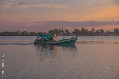 Khmer fishing boat heading out to sea in Kampot Cambodia