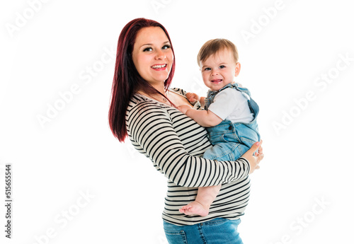 Cheerful baby boy toddler with his mother on white studio background