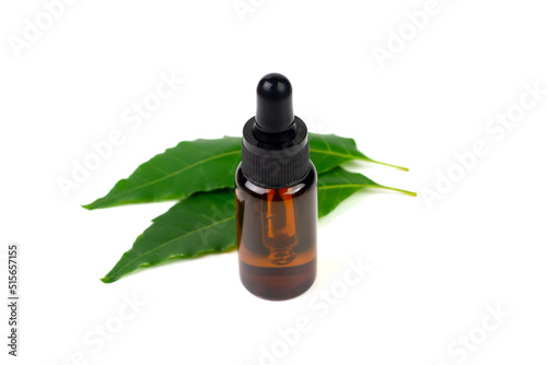 Neem oil in bottle and fresh neem leaf isolated on white background.