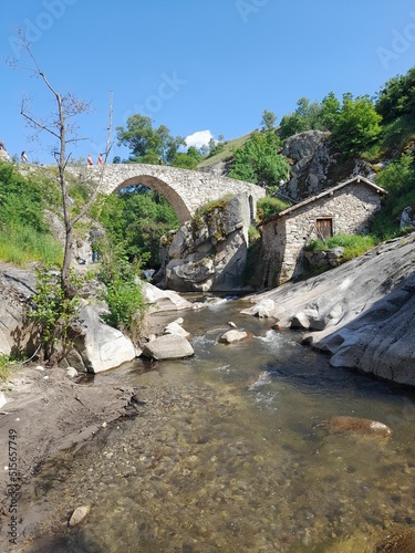 Vertical shot of an arched stone bridge in Mariovo, Macedonia in sunny weather photo