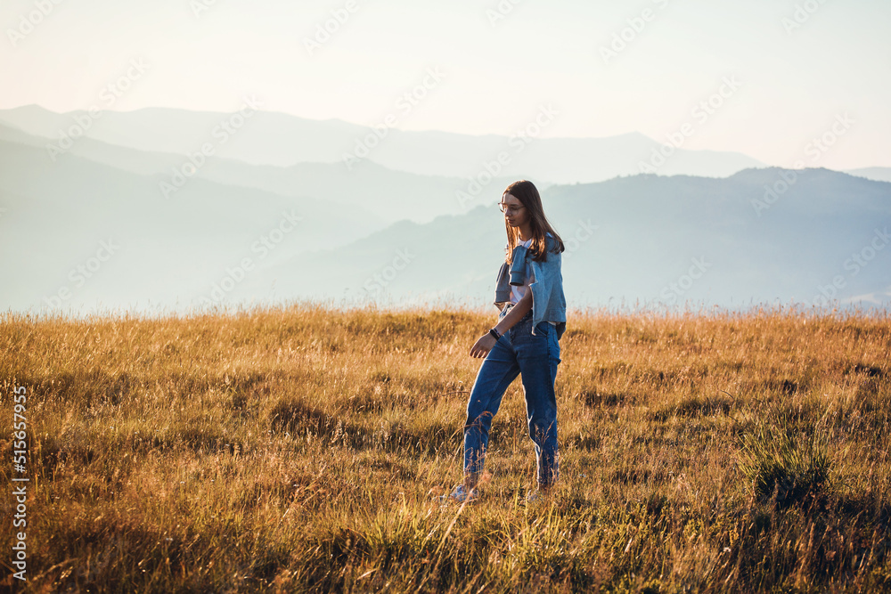 Pretty Teen Girl Walking in Mountain Sunrise Landscape