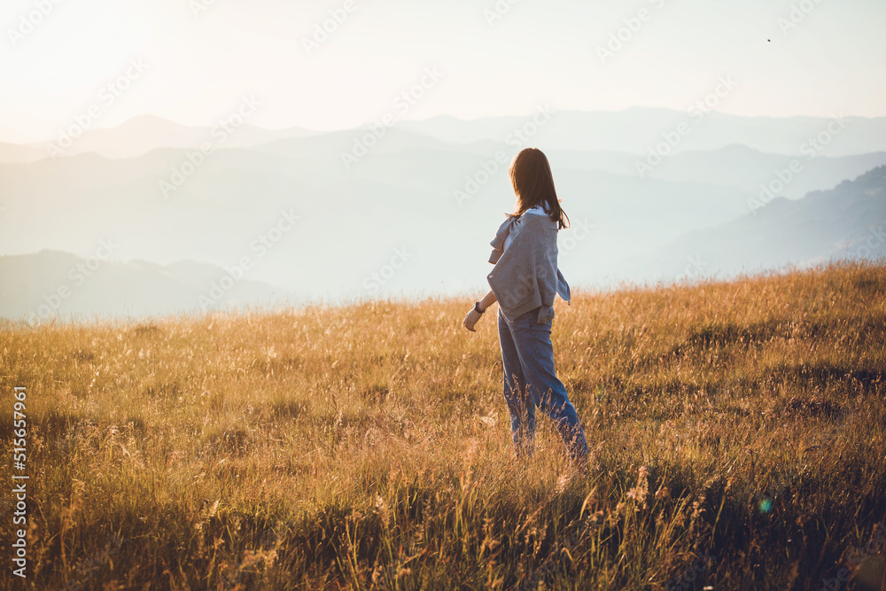 Pretty Teen Girl in Beautiful Mountain Landscape at Morning Sunrise