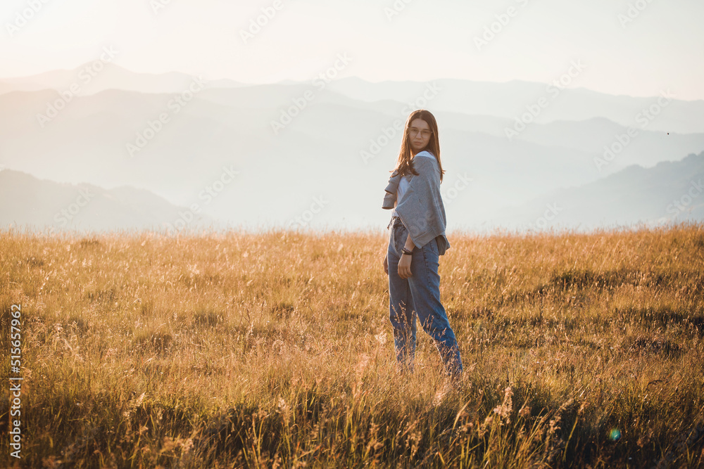 Happy Teen Girl in Golden Mountain Sunrise Landscape 