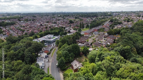 Fotografi Aerial view looking down onto buildings and roads with views towards Manchester City centre in the background