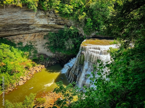 Scenic view of Burgess Falls surrounded by dense trees in the forest photo