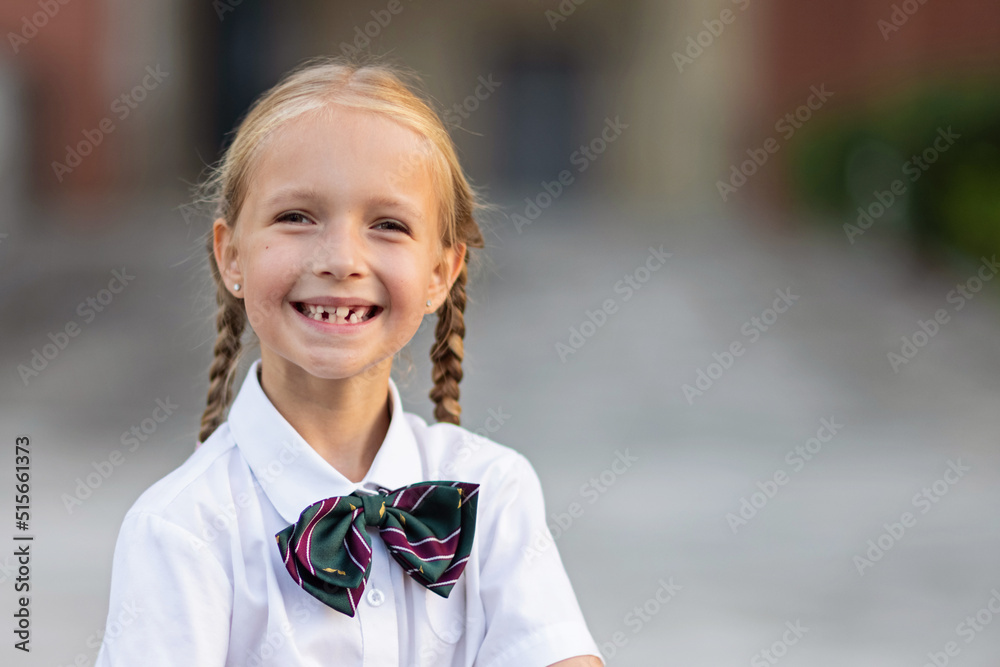 Schoolgirl back to school after summer vacations. Child in uniform standing early morning outdoor. Schoolgirl back to school after summer vacations. Child in uniform standing early morning outdoor.