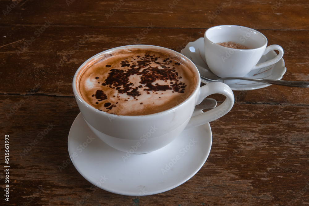 A cup of coffee topped with cinnamon A cup of coffee topped with cinnamon