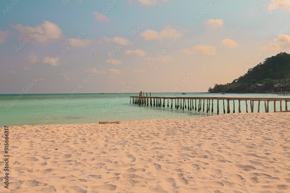 Dreamy summer scene of a wooden boardwalk leading to the vast sea horizon in Koh Rong island in Cambodia, a popular travel destination