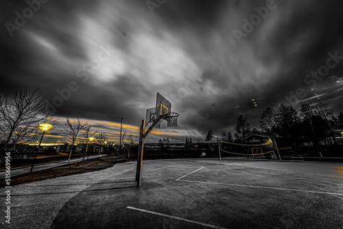 Breathtaking view of a basketball and volleyball courts against dark cloudy sky background © Gude Smokiedoc Tokerud/Wirestock Creators