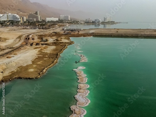 Aerial view of the shore of  the Dead Sea, near Neve Zohar, Israel with salt formation on the water photo