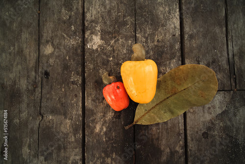 Top view of cashew fruit or anacardium occidentale on a wooden background photo