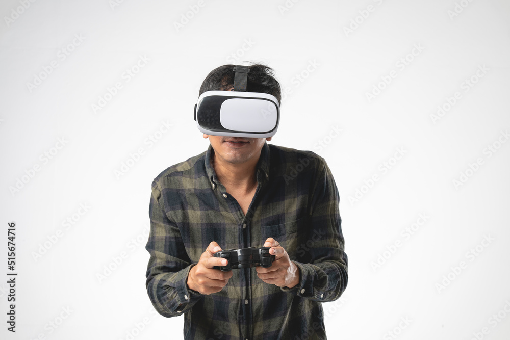 Asian handsome man with using virtual reality headset or VR glass with joystick isolate on gray background Asian handsome man with using virtual reality headset or VR glass with joystick isolate on gray background