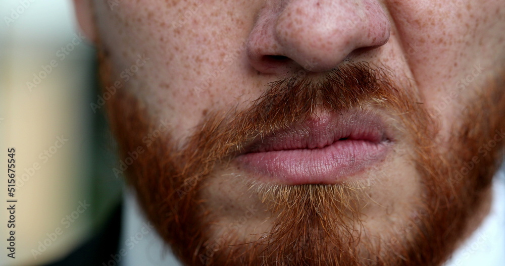 Obraz premium Upset man snarling close-up eyes and mouth. Redhead red beard grimacing angry person