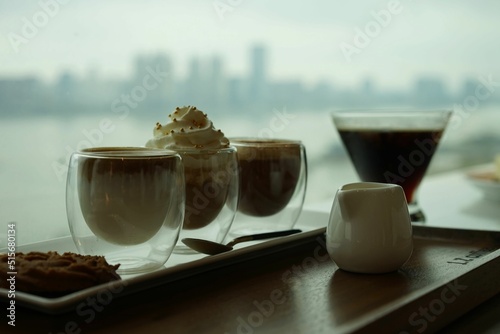 Selective focus shot of perfecr coffee selection with a blurred view of the Wuhan city skyline photo