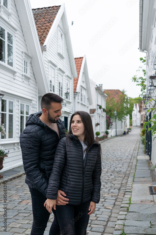 Couple in love looking at each other on a tourist street in Stavanger, Norway.