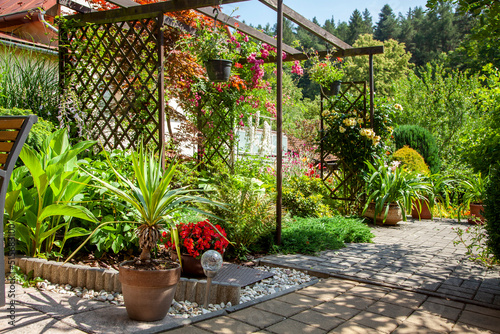 Beatiful backyard garden with flowers in full bloom in sunny day in summer.

