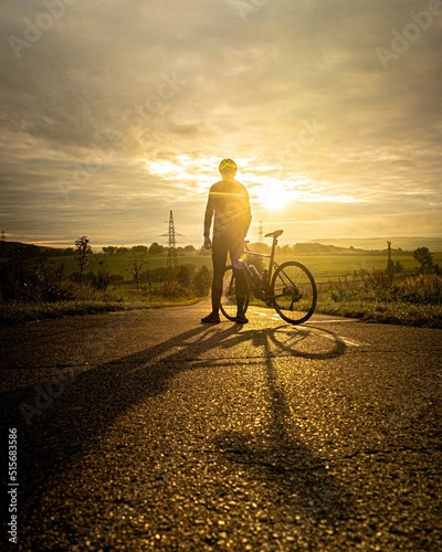 Man on gravel bike watching sunset photo