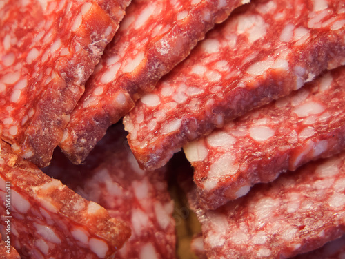 Smoked sausage, full frame. Pieces of appetizing meat snack close-up. Salami Background, meat delicatessen