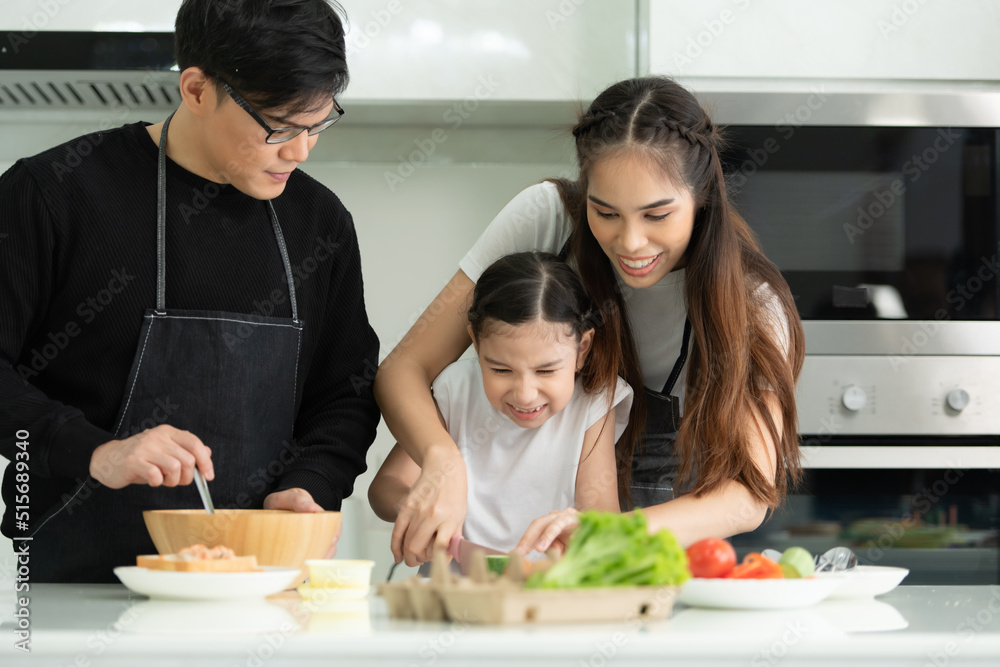 Asian family They are having cooking together happily in the kitchen room of the house. Asian family They are having cooking together happily in the kitchen room of the house.